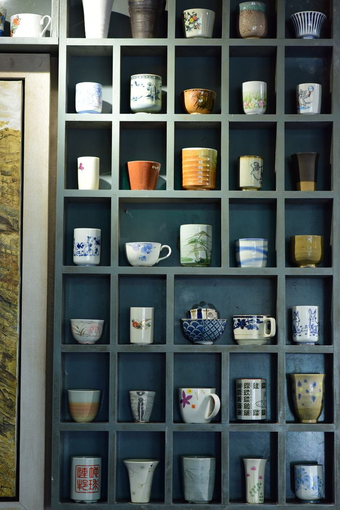 Mastering the First Impression: Your intriguing post title goes here A variety of decorative ceramic cups and mugs arranged on a display shelf, showcasing diverse designs and colors.
